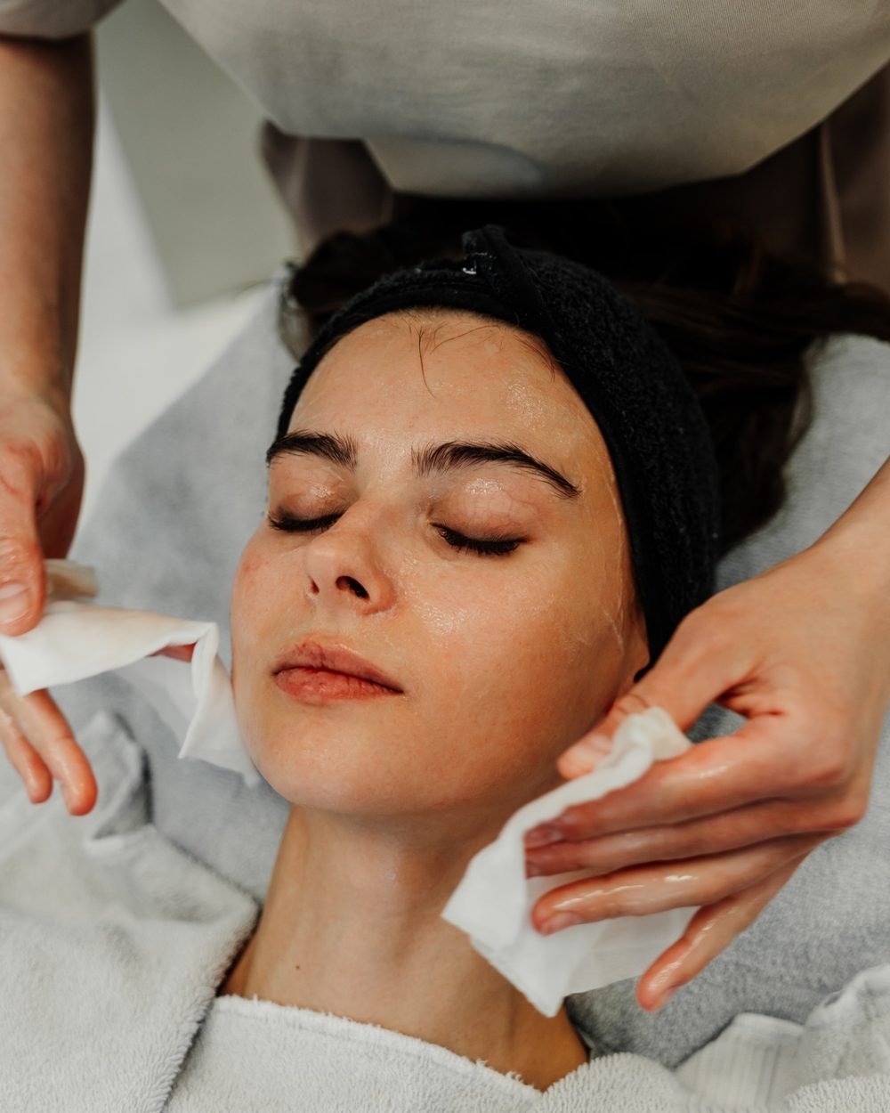 Professional facial skin care. A master massages a woman's face in a beauty salon.